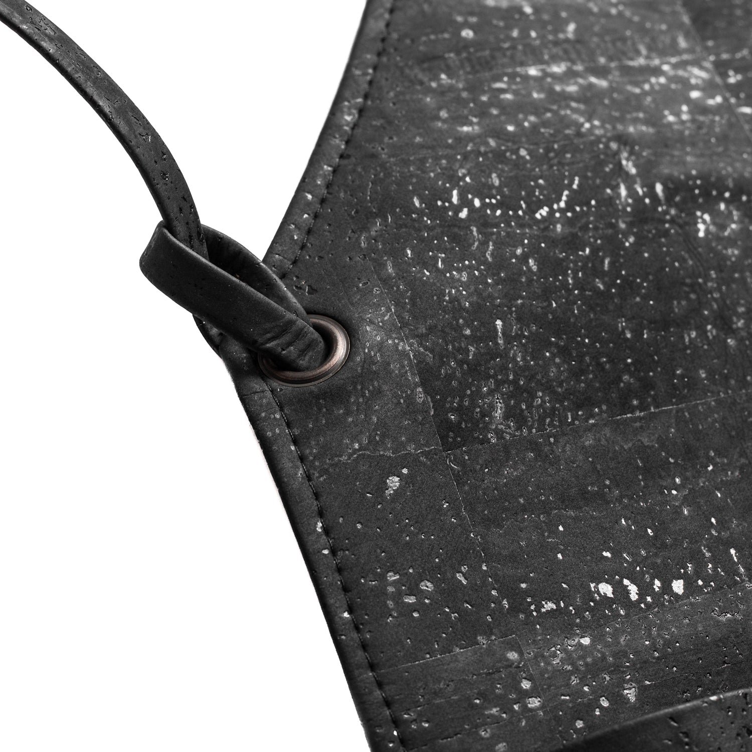 Close-up of a black textured cork leather bag with a strap design by Mellow Fellow